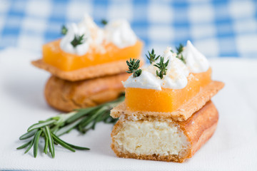 Cut delicious eclair closeup cream decorated with fresh thyme