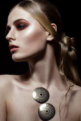 Beautiful fashion woman with creative make-up and hairstyle wearing glasses and jewelry. The beauty...