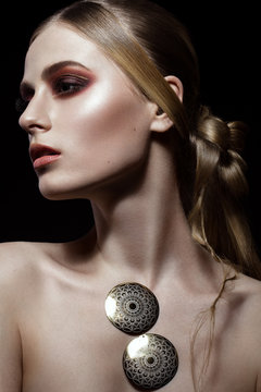 Fototapeta Beautiful fashion woman with creative make-up and hairstyle wearing glasses and jewelry. The beauty of the face. Photos shot in the studio.