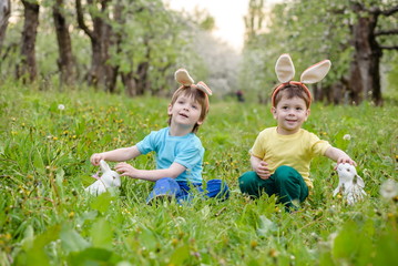 Naklejka na ściany i meble Two little kids boys and friends in Easter bunny ears during tra