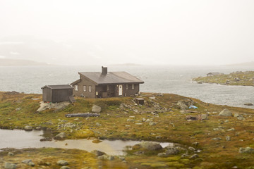 Landscape of Norway, mountains and shed, view from train