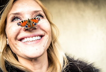 Woman portrait with butterfly on her nose