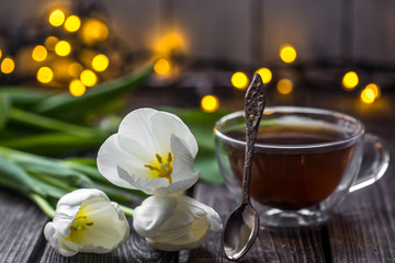 Fototapeta na wymiar white tulips and a Cup of tea