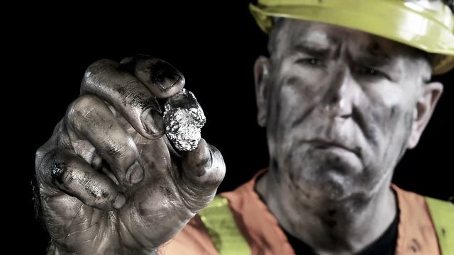 Conceptual video of a silver miner examining his precious metal discovery..