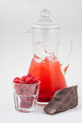 glass decanter with raspberry juice, chocolate and ice