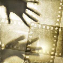 Two hands on vintage film strip frame. - 135186726