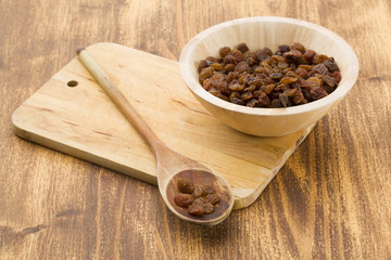 Raisins on a wooden spoon