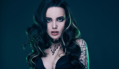 Portrait of young sexy gothic girl with long hair