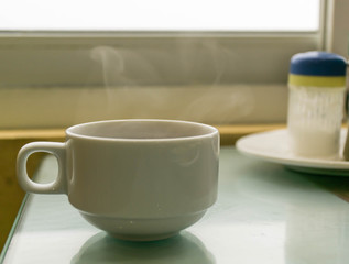 Fototapeta na wymiar hot tea with smoke in morning time 