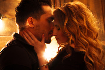 Beautiful couple in love hugging against the background of glowi
