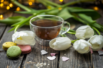 white tulips and a transparent Cup of tea