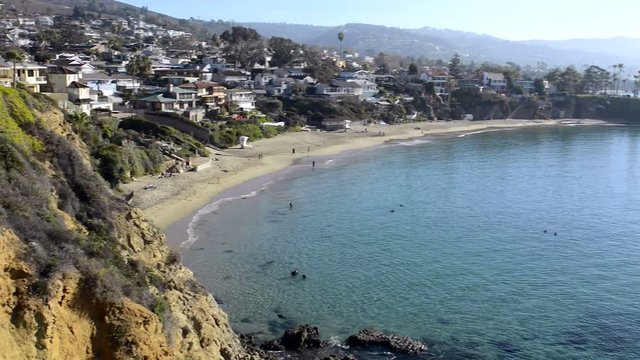 A beautiful pan of Shaws Cove in Laguna Beach, California shows the high style of living along scenic, horseshoe oceanfront