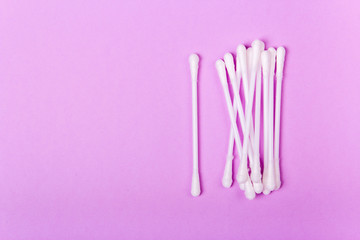 closeup clean ear sticks on violet background slide