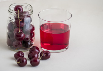 glass of fresh cherry juice and fresh cherries