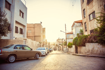 old street with parked cars in city of Amman, Jordan