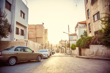 Fototapeten old street with parked cars in city of Amman, Jordan © popovatetiana