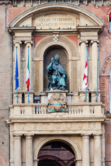 statue on facade of palazzo in Bologna city