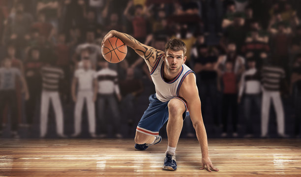 basketball player on court with ball in lights