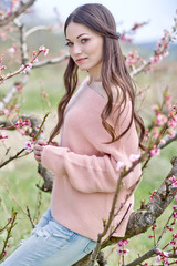 Fototapeta premium Beautiful woman in a spring garden 