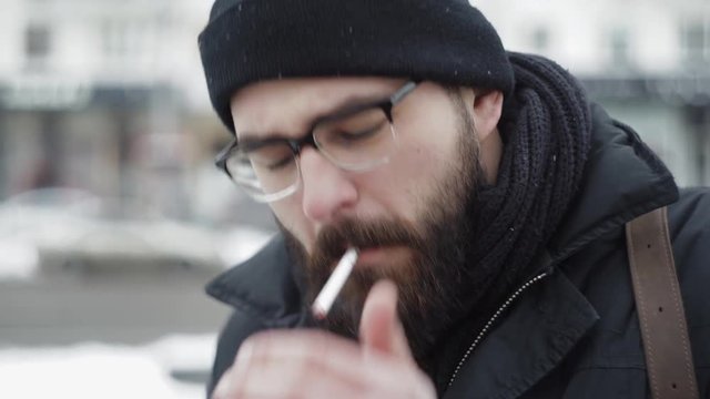 Hipster man smoking cigarette on the street hd