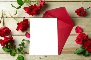 Love letter and valentine red roses on wooden background.  Valen