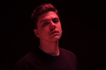 one man looking above up, red color light