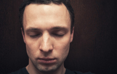 Young Caucasian man with closed eyes