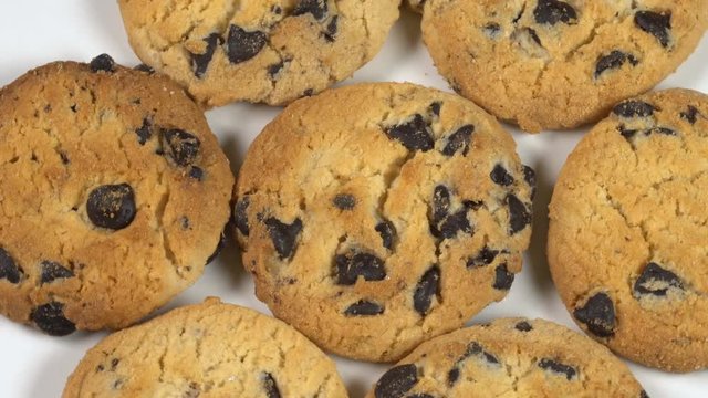 Biscuit Cookies with chocolate raisins rotates on a white table 4K