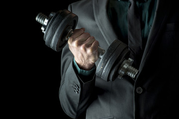 Businessman in formal suit lifting weights