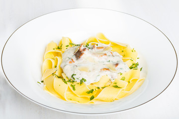 Pasta with cream sauce with chanterelle