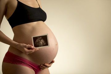 Pregnant woman with embryo picture