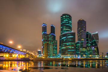 Panoramic night view on skyscrapers of the Moscow City International Business Center near river Moscow and Dorogomilovskiy bridge, Moscow, Russia.