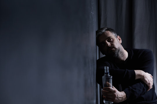 Man with alcohol bottle