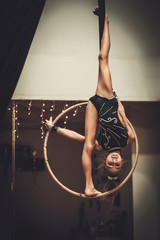 Plastic little girl gymnast on acrobatic ring © Nejron Photo