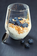 Dietetic breakfast - yoghurt with muesli and huckleberries