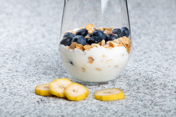 Dietetic breakfast - yoghurt with mueasli and huckleberries and banana
