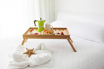 Fototapeta na wymiar Breakfast tray with coffee on bed