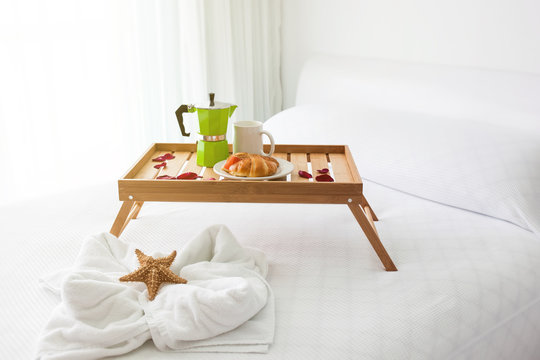 Breakfast tray with coffee on bed