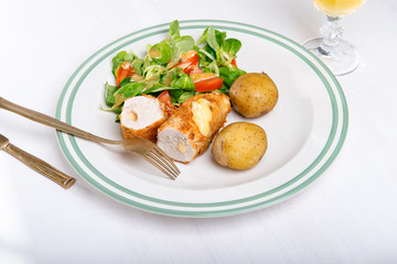 Kiev cutlet with jacket potatoes and salad