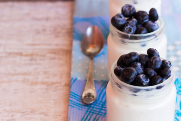 Yogurt with berries in a glass jar. Place in the text