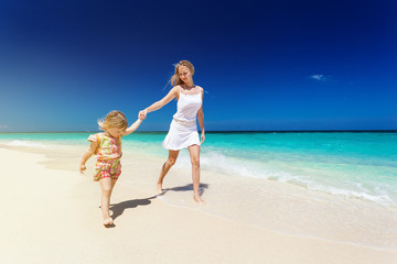 Mother and daughter having fun on beach