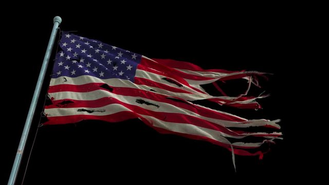 American torn and tattered flag waves in the wind. (Looped, with alpha channel)
