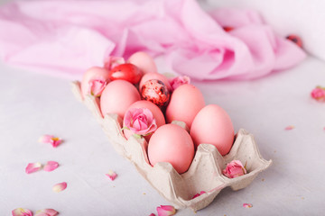 Pink Easter eggs on light background. Copyspace. Still life photo of lots of pink easter eggs.Background with easter eggs. Pink eggs and roses. Easter photo concept