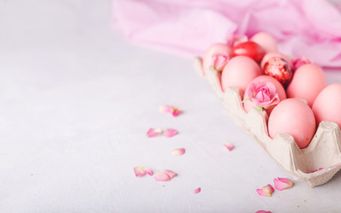 Pink Easter eggs on light background. Copyspace. Still life photo of lots of pink easter eggs.Background with easter eggs. Pink eggs and roses. Easter photo concept