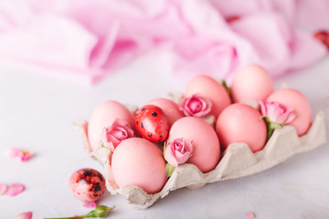Obraz na płótnie Canvas Pink Easter eggs on light background. Copyspace. Still life photo of lots of pink easter eggs.Background with easter eggs. Pink eggs and roses. Easter photo concept