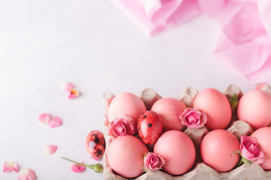 Pink Easter eggs on light background. Copyspace. Still life photo of lots of pink easter eggs.Background with easter eggs. Pink eggs and roses. Easter photo concept