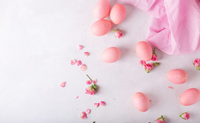 Obraz na płótnie Canvas Pink Easter eggs on light background. Copyspace. Still life photo of lots of pink easter eggs.Background with easter eggs. Pink eggs and roses. Easter photo concept