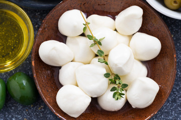 Fresh mozzarella cheese on a plate, top view, close-up
