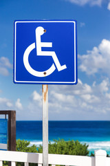 Blue handicapped sign with wheelchair, outdoors