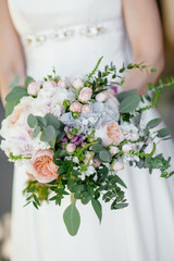 the bride holding a bouquet. wedding flowers. soft focus.